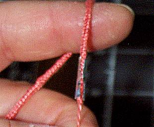 threading the cord through the half-formed aiguillette